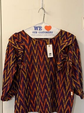 Folklore Las Niñas Girl’s Ruffled Chevron Print Blouse in Purple and Orange